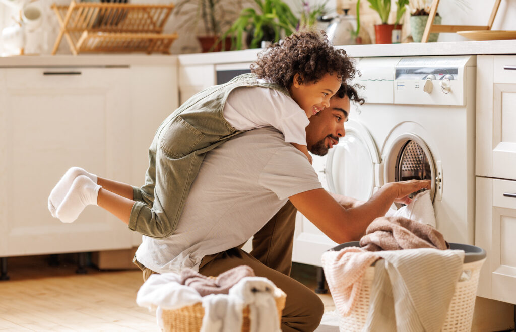 Father and son doing laundry together | Motherhues