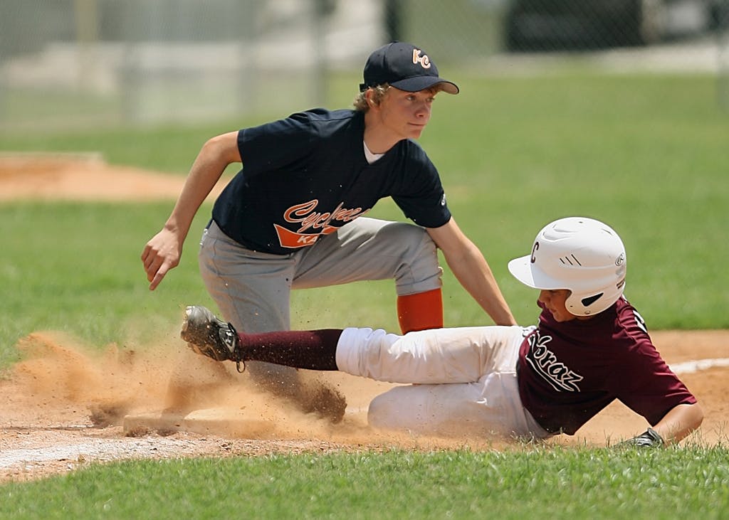 Photo by Pixabay | Motherhues Man Kneeling Trays to Stop Man While Hes Sliding Towards Base