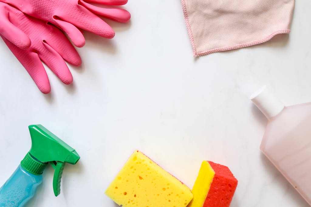 Photo by Polina Tankilevitch | Motherhues A flat lay of assorted cleaning supplies, perfect for housekeeping themes.