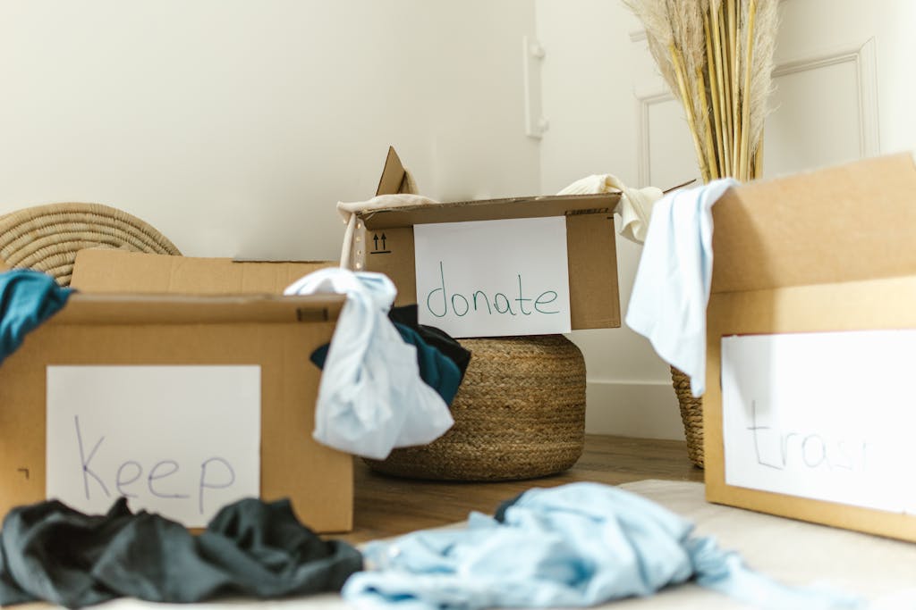 Photo by RDNE Stock project | Motherhues Cardboard boxes labeled keep, donate, and trash for effective home organization.